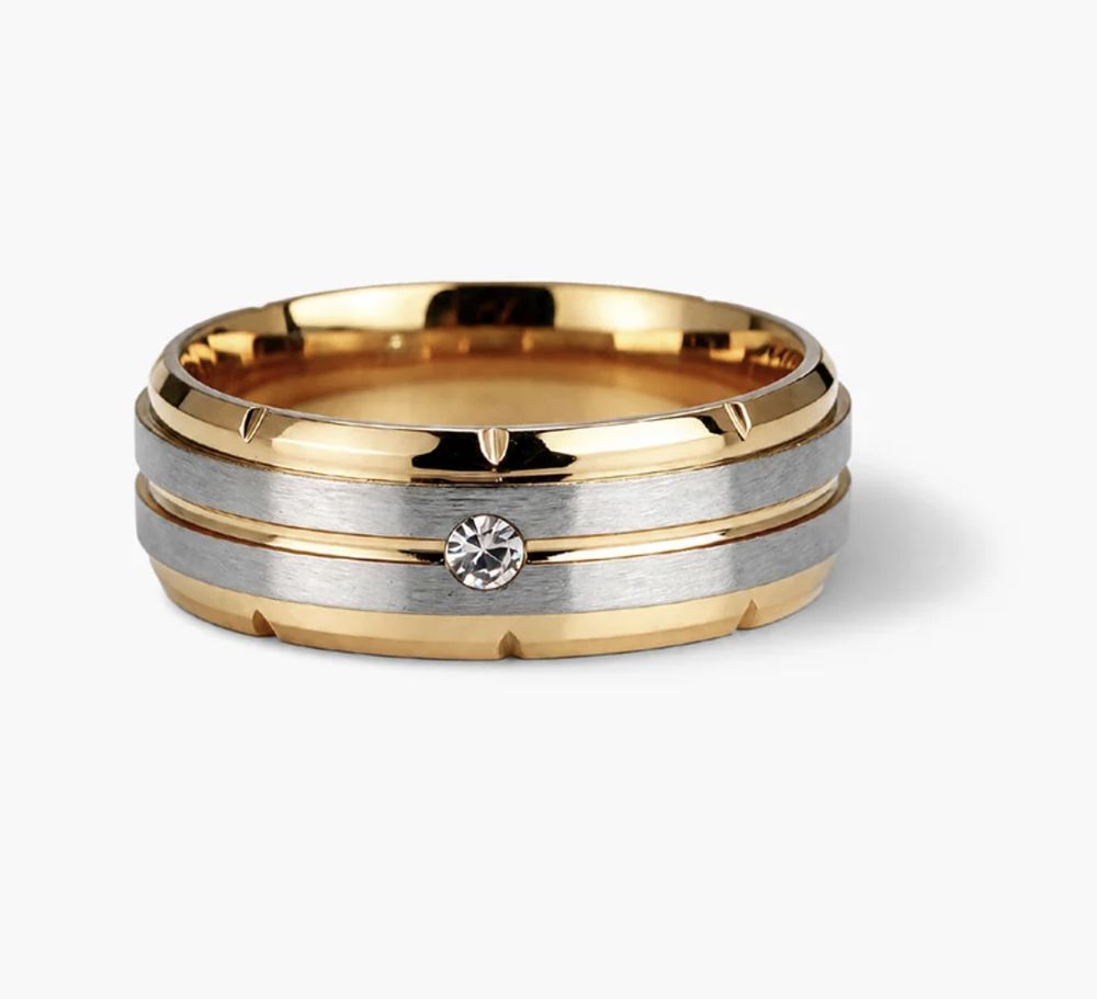 A men's band ring in gold and brushed steel, photographed flat on white for a listing.