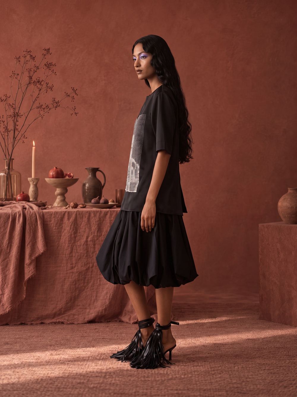 Side profile of the black tee and bubble skirt.