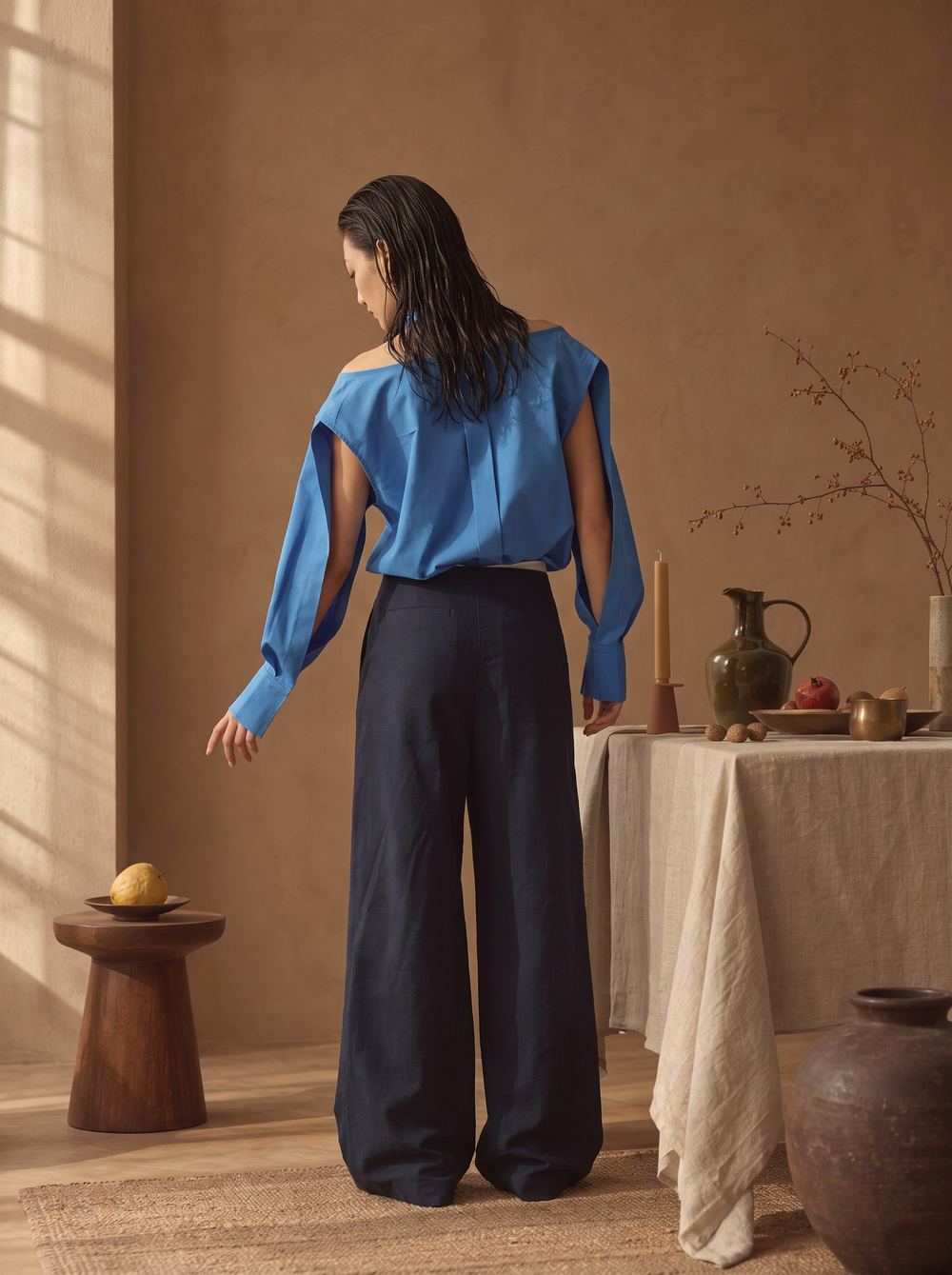Rear view of the blue shirt and navy trousers.