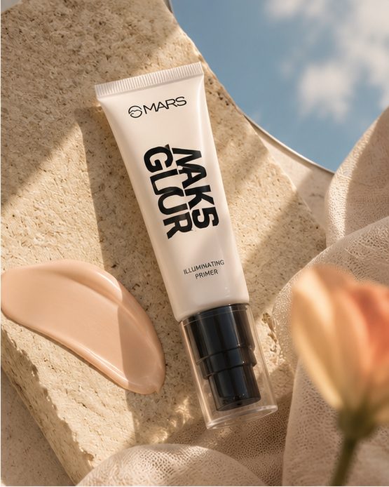 An illuminating primer lying flat on a limestone slab beside a smooth swatch of the product, soft fabric and a peach tulip around it.