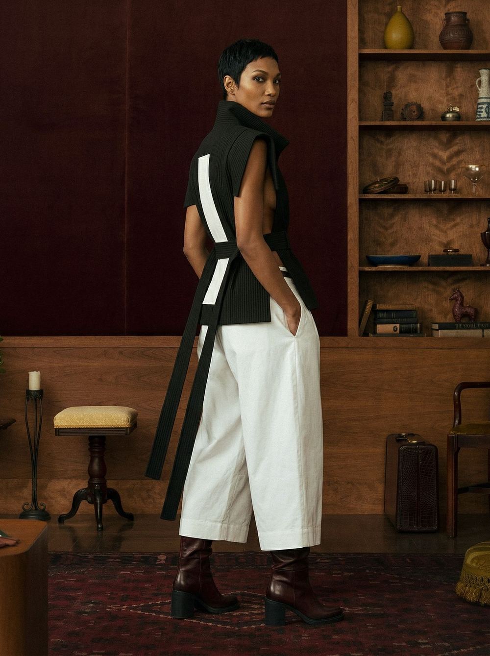 Rear view of the black vest and its white sash over a white skirt.